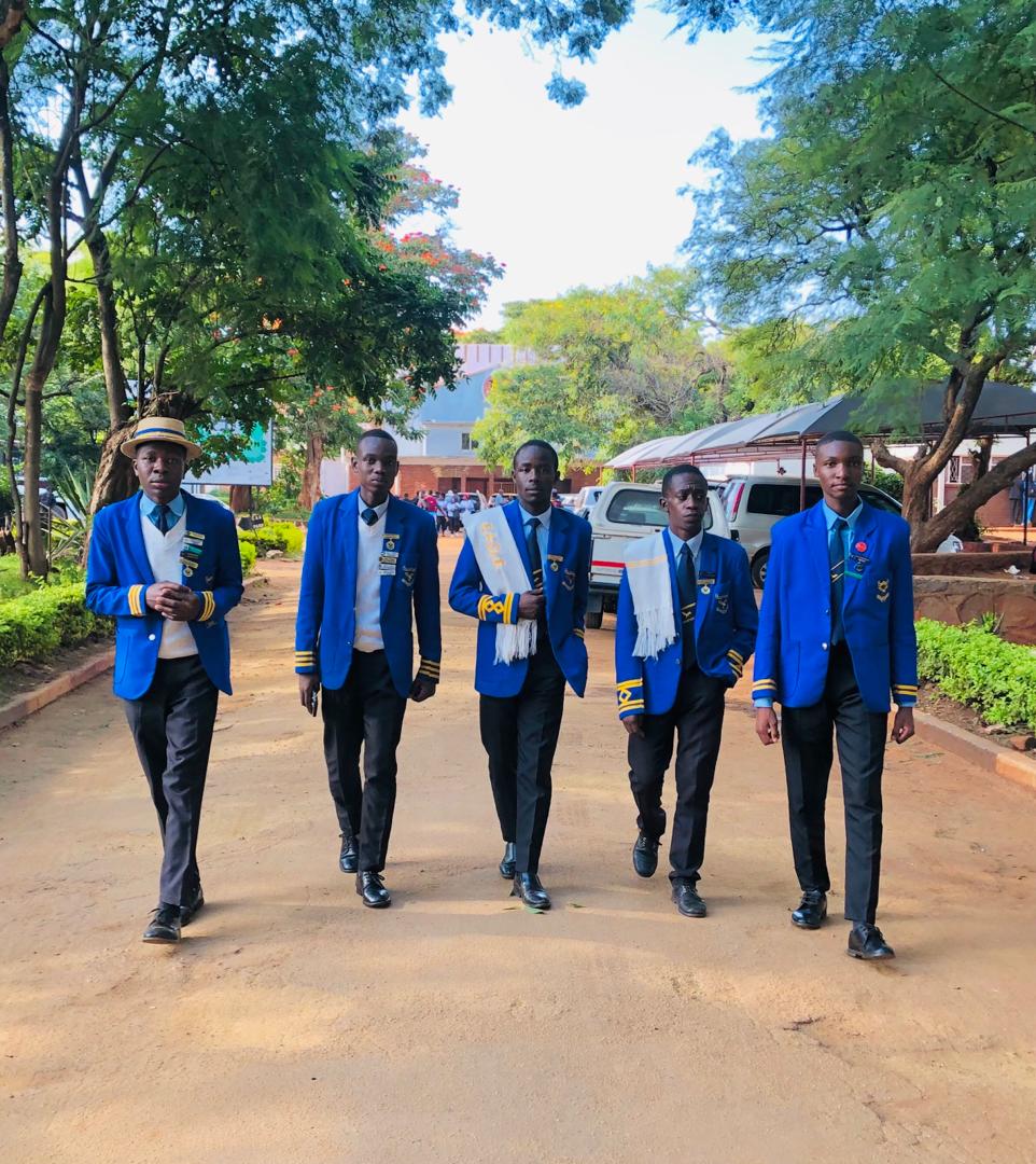 Students in blazers walking through campus